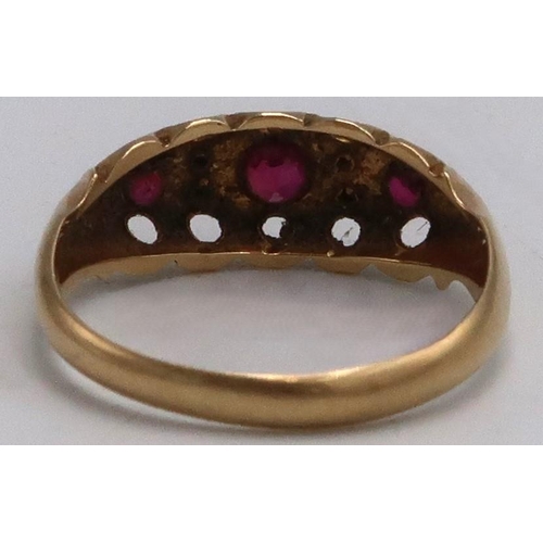 13 - An 18ct yellow gold dress ring  with three rubies and four small diamonds, ring size K, approx 2.2 g... 