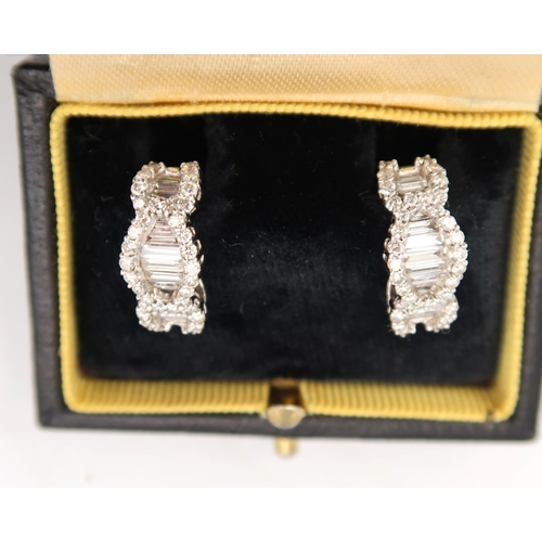 132 - A pair of good quality 18ct white gold diamond earrings consisting of baguette and brilliant cut dia... 