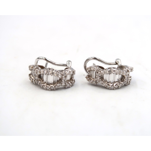 132 - A pair of good quality 18ct white gold diamond earrings consisting of baguette and brilliant cut dia... 