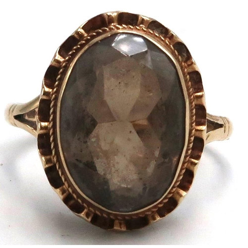 16 - A 9ct marked yellow gold dress ring with oval Smokey Quartz to shoulder, 3.7grams, Size M/N