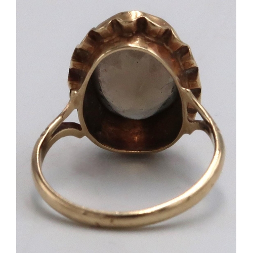 16 - A 9ct marked yellow gold dress ring with oval Smokey Quartz to shoulder, 3.7grams, Size M/N