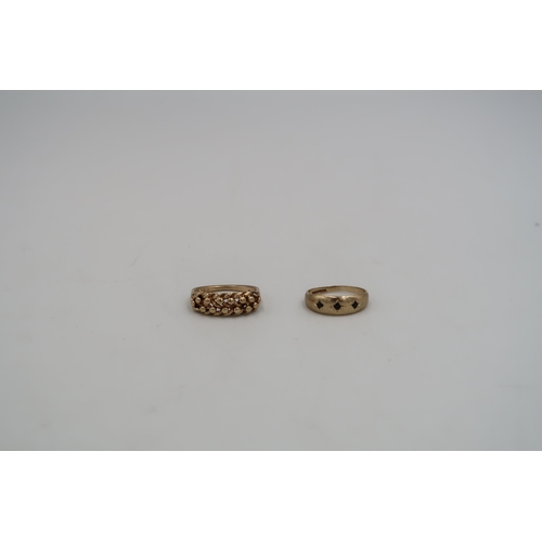 190 - Two 9ct yellow gold stamped rings - one with knotted rope design to shoulder, one with three small g... 