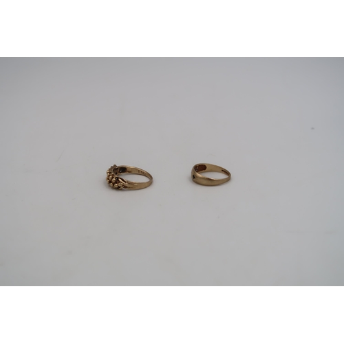 190 - Two 9ct yellow gold stamped rings - one with knotted rope design to shoulder, one with three small g... 