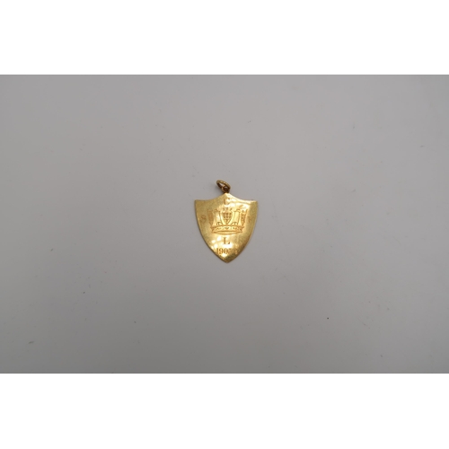 209 - An 18ct tested shield shaped medallion - approx weight 4.8 grams - engraved to front with suspension... 