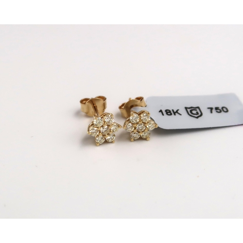 33 - A pair of 18ct gold brilliant cut diamond flower cluster studs. Stated diamond weight 0.56ct. Weight... 