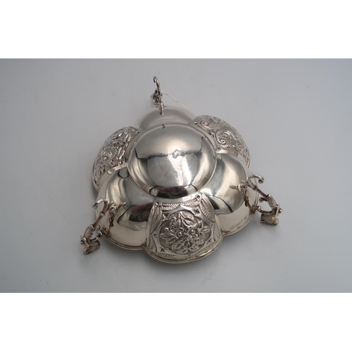 338 - A hallmarked silver sweet meat dish raised on three supports with animal head handles, embossed foli... 