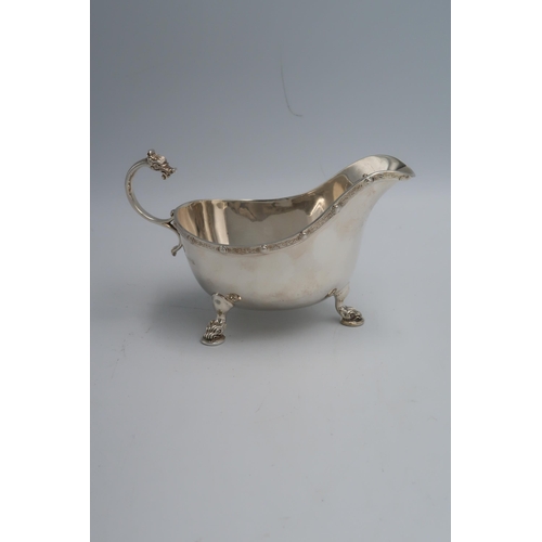 339 - A hallmarked silver milk jug with Dragons head handle and tri hoof feet Birmingham, in good conditio... 