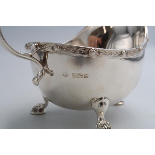 339 - A hallmarked silver milk jug with Dragons head handle and tri hoof feet Birmingham, in good conditio... 