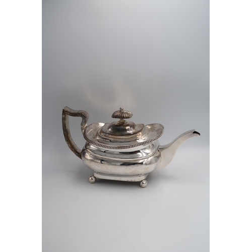 343 - A hallmarked silver Georgian teapot circa 1815 London with ribbed decoration raised on ball feet - a... 