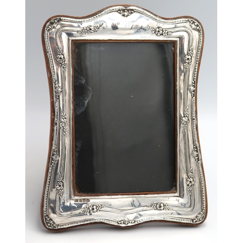 347 - A Silver H.M. photo frame, Birmingham 1925, decorated with embossed floral decoration. 13cm x 9cm. I... 