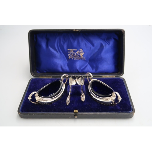 353 - A boxed pair of silver salts with original matching blue glass liners and spoons - hallmarked for Bi... 