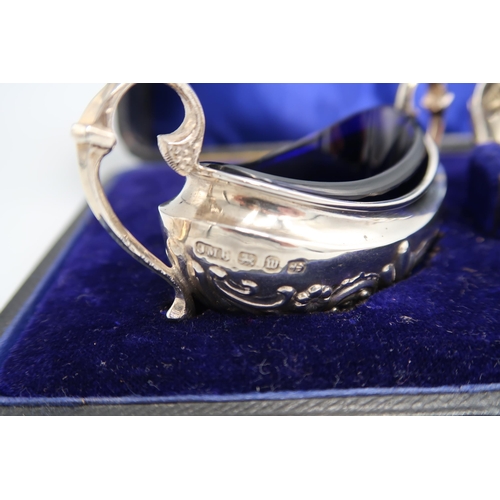 353 - A boxed pair of silver salts with original matching blue glass liners and spoons - hallmarked for Bi... 