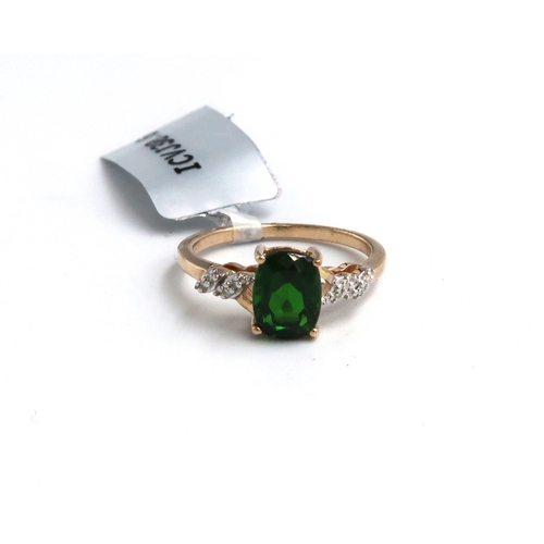 37 - A 9ct gold oval diopside ring with single cut diamond highlights to each shoulder. Size M. Weight 2.... 