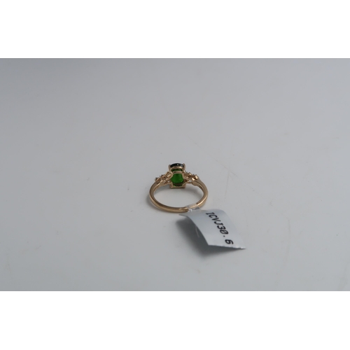 37 - A 9ct gold oval diopside ring with single cut diamond highlights to each shoulder. Size M. Weight 2.... 