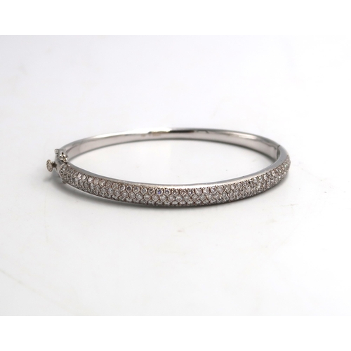 41 - A brilliant cut diamond pave set hinged bangle. Stated weight 3.22cts. Estimated G/H colour, VS/SI c... 