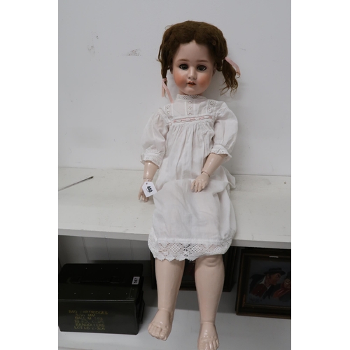 440 - A Schoenan and Hoffmeister bisque headed Doll impressed 1906 15 with brown wig, closing blue eyes, o... 