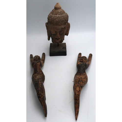 457 - An antique hand carved Cambodian Buddha head on stand 24cm high along with two carved wooden Mermaid... 