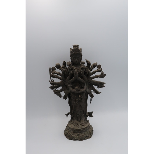 458 - A Sino-Tibetan bronze figure of a Bohisattva with numerous arms standing. 28cm high, in good conditi... 