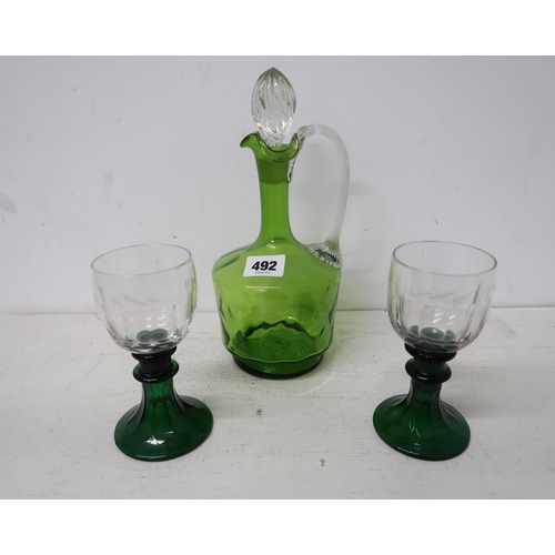 492 - A green glass decanter and two glasses