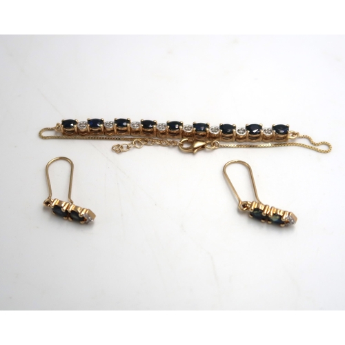 52 - A sapphire and diamond line bracelet and a pair of sapphire and zircon ear pendants. Stamped 9K. Wei... 