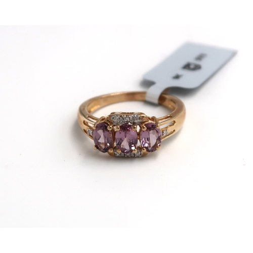 54 - A 9ct gold purple spinel and diamond dress ring. Size O. Weight 2.88 grams.