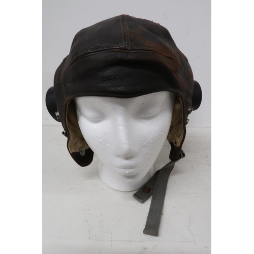 541 - A Lancaster flying helmet with headphones, intercom cable and goggles - in worn but reasonable condi... 