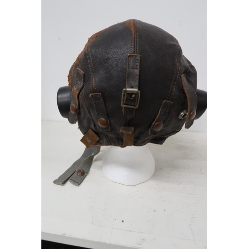 541 - A Lancaster flying helmet with headphones, intercom cable and goggles - in worn but reasonable condi... 