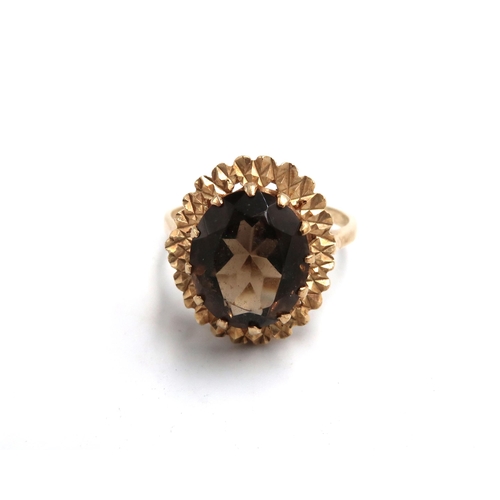 57 - A hallmarked 9ct yellow gold dress ring with oval cut Smokey quartz to shoulder - approx weight 4.3 ... 