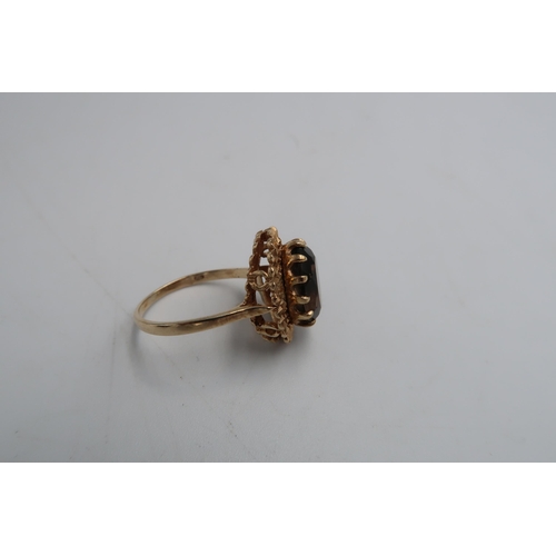 57 - A hallmarked 9ct yellow gold dress ring with oval cut Smokey quartz to shoulder - approx weight 4.3 ... 