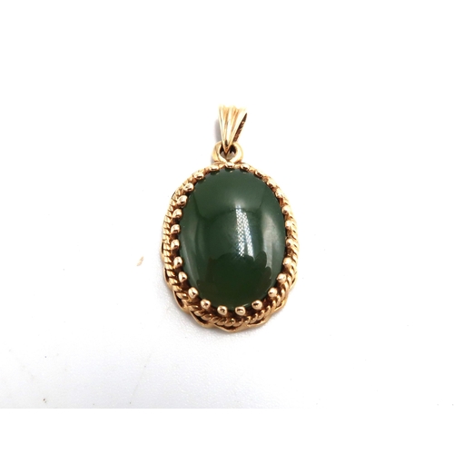 58 - A 14ct marked oval yellow gold pendant with oval cut green agate to centre - approx weight 3.9 grams... 