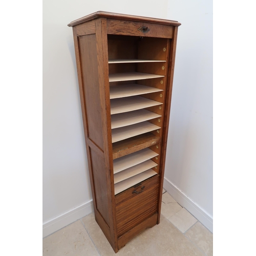 628 - A 1930's oak tambour fronted filing cabinet with an nice colour and good condition, with replaced sh... 