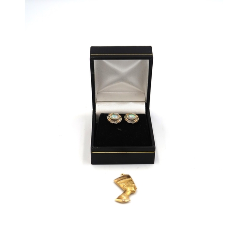 63 - A pair of 9ct white and yellow gold earrings set with oval opals and diamonds and a 9ct Egyptian hea... 