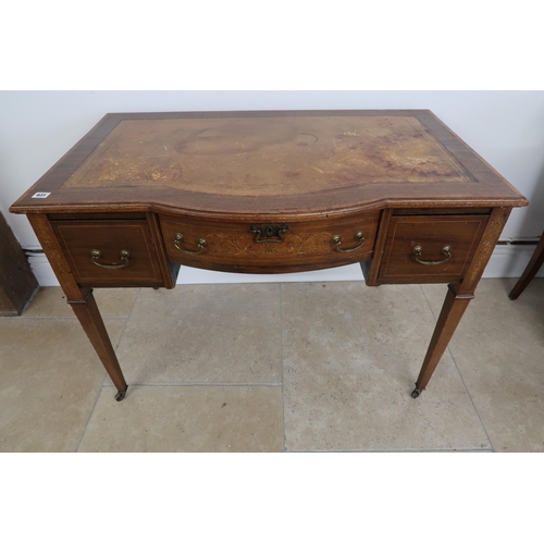 631 - An Edwardian Mahogany bow front writing desk with tooled leather top, central bow fronted inlaid dra... 