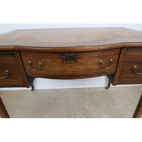 631 - An Edwardian Mahogany bow front writing desk with tooled leather top, central bow fronted inlaid dra... 