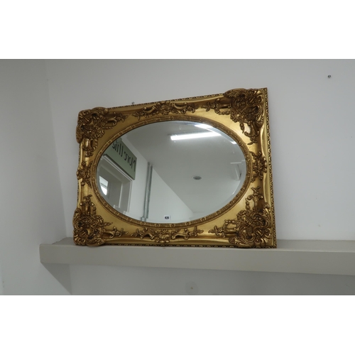 635 - A modern gilt framed oval bevelled mirror - 94cm x 68cm, mirror size 74cm x 49cm - in good condition