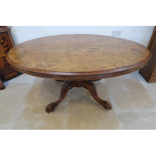 648 - A 19th century oval breakfast table with a quarter veneered top and four out swept legs - in sound c... 