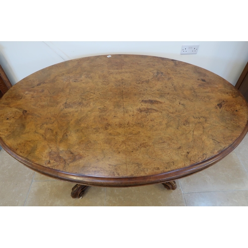 648 - A 19th century oval breakfast table with a quarter veneered top and four out swept legs - in sound c... 