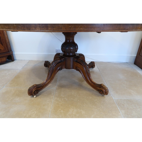 648 - A 19th century oval breakfast table with a quarter veneered top and four out swept legs - in sound c... 