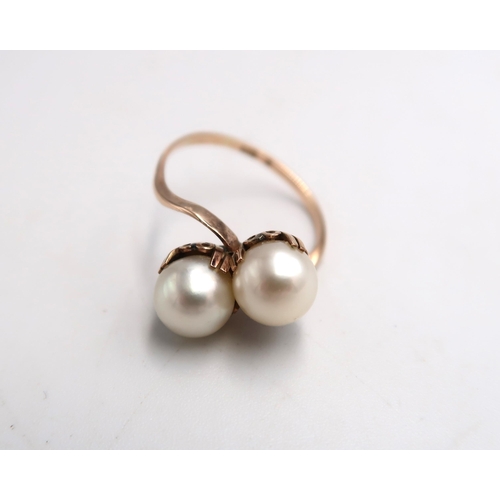 65 - A K10 marked two pearl dress ring - the pearls 7mm in diameter set to shoulder - ring size N/O - app... 