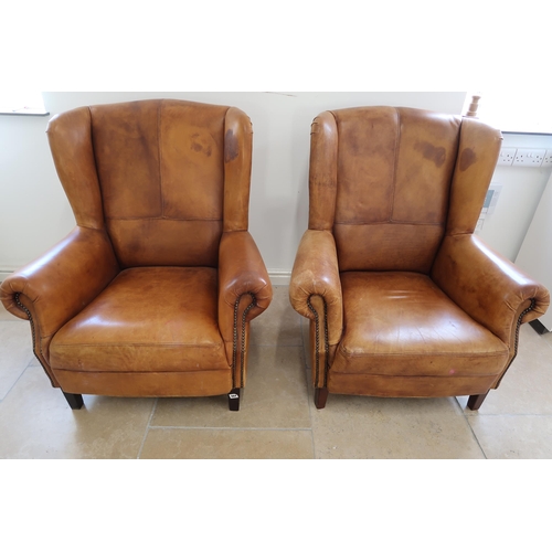 664 - Two brown leather upholstered wingback armchairs with distressed finish - in good condition - Height... 