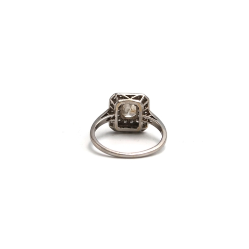 7 - An Asscher cut diamond cluster ring. The central Asscher cut diamond estimated 0.65ct, estimated I/J... 