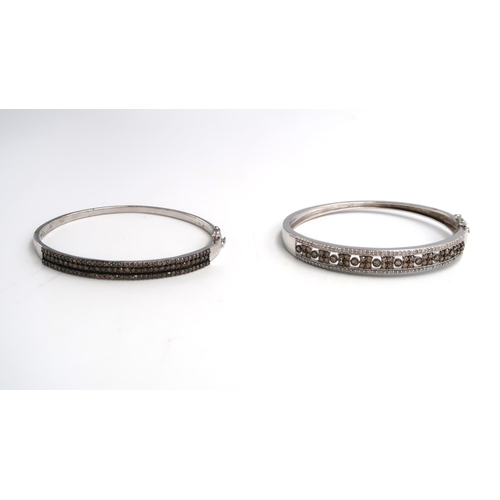 74 - Two silver hinged bangles set with diamond and champagne diamonds. One designed as three rows of bri... 