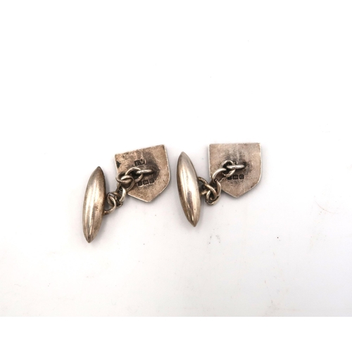 160 - A pair of 18ct stamped white gold cufflinks of octagonal design with pearl and mother of pearl to ce... 