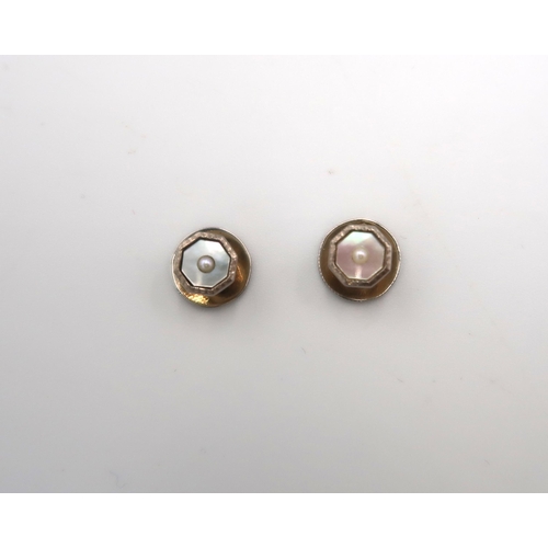 160 - A pair of 18ct stamped white gold cufflinks of octagonal design with pearl and mother of pearl to ce... 