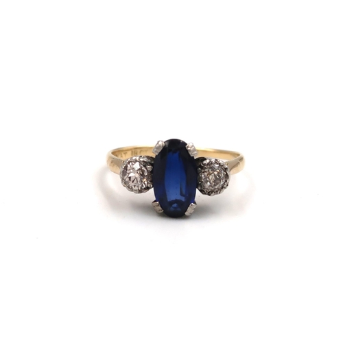 214 - An oval sapphire and old cut diamond three stone ring. Estimated total diamond weight 0.60ct. Stampe... 