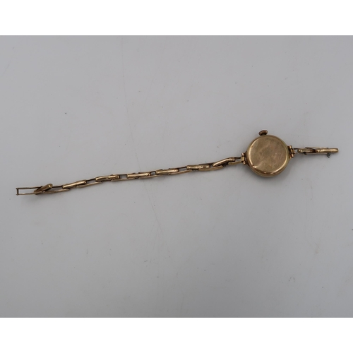 284 - A ladies 9ct hallmarked yellow gold wristwatch on 9ct marked gold bracelet strap - silvered dial wit... 