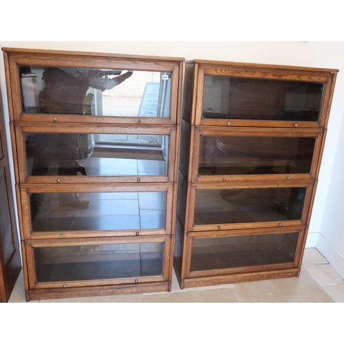 629 - A pair of good quality Globe Wernicke style four section oak bookcases with labels for The Butterwor... 