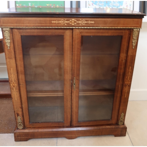 642 - A 19th century walnut and inlaid pier cabinet with two glazed doors - good condition but two small m... 