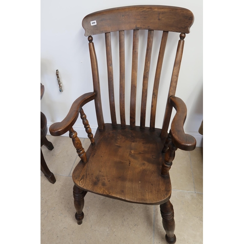 699 - A circa 1900's elm Windsor stick back armchair - Height 111cm x Width 61cm x Depth 70cm