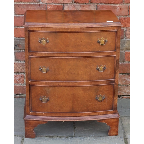 708 - A small walnut veneered bow fronted chest of three long graduated drawers raised on bracket supports... 